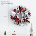 30cm Christmas wreath with red berries, pine cones, and flocked snow needles on white wall - 30cm Wine Red Wreath