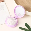 Portable folding round hairbrush with built-in mirror in purple for travel convenience - Purple