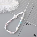Detailed view of handmade beaded phone strap with pearls and colorful heart charms - Star Shell