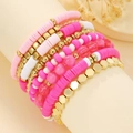Detail of multi-layer pink and white heishi bead bracelets with gold hex accents - Pink White Gold Set
