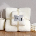 White coral fleece towel set tied with cream ribbon on a rustic wooden tabletop - Towel + Bath Towel [Mesh Bag] / White Coral Fleece