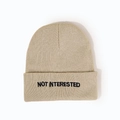 Close-up of khaki knit beanie featuring black 'NOT INTERESTED' letter embroidery on cuff - M (56-58cm) / Beige