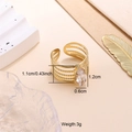 Macro detail of gold open ring featuring layered bead bands and a large marquise zircon - White