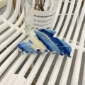 Blue and yellow marble pattern acetate hair claw clip shown on a minimalist chair - Blue White Handmade Striped Style