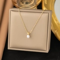 Gold-plated titanium necklace with faceted bead and white teardrop pearl pendant - Perfume Bottle Necklace Gold