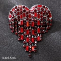 Silver heart brooch with red rhinestones and hanging tassels on a dark background - Heart Red Crystal Tassel