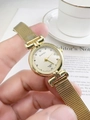 Close-up of golden vintage quartz watch with diamond dial and mesh metal strap on wrist - Gold Steel Strap Gold Dial