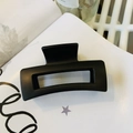 Close-up of a matte black square hair claw clip on a minimalist white aesthetic background - Matte Black