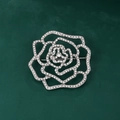 Elegant silver rose brooch with hollow rhinestone petals on a dark green background - XD11378-1 Silver Hollow Rose