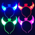 LED devil horn headbands with heart detail in four glowing colors on black background - Glowing Devil Horns (Mixed Colors)