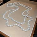 French vintage glass pearl necklace with elegant luster displayed on a velvet jewelry tray - White