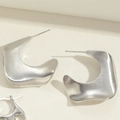 Detailed shot of asymmetric matte silver earrings with a brushed metallic texture finish - Polished Geometric Earrings (ES2344-6)