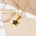 Minimalist gold necklace with black star pendant featuring a gold letter S on a stone base - Letter S Style (D112)