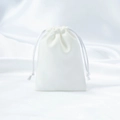 Elegant white satin drawstring jewelry pouch with smooth silk texture for gift storage - White