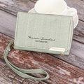 Detail of short green wallet with Forever Sunshine text and herringbone fabric texture - Light Green