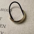 Close-up of golden geometric metal hair tie on beige textured canvas background - Semi-Circle Gold (D-5336-7)