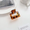 Oversized leopard print square hair claw clip in tortoise shell finish on a white desk - 5cm / Caramel Brown Small