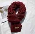 Dark red knitted winter scarf in handmade style, folded on a minimalist background - Handmade Label Solid Style / Solid Wine Red
