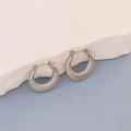 Detail view of silver oval hoop earrings with grid embossed texture on stone - Silver Rhombus Embossed Hoop