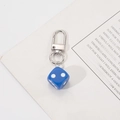 Close-up of a deep blue six-sided dice keychain with a polished silver lobster clasp - Blue Dice
