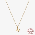 Macro shot of 18K gold plated S925 sterling silver initial N pendant with textured finish - Gold - Letter N