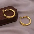 Elegant gold twisted hoop earrings with textured finish and pin closure design - Twisted Shape Hoop / E-064---Gold