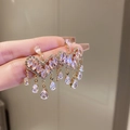 Detailed shot of golden heart-shaped fringe earrings with pink zircon stone settings - Pink Heart Tassel (9#)