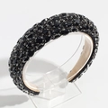 Detailed close-up of a baroque headband featuring black crystals and beige fabric lining - Black