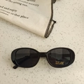 Kids oval sunglasses with black frames and dark UV400 lenses on a textured stone surface - Black and Gray