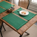 Green woven cotton placemat with striped texture and decorative fringe on a wooden table - Green Union Jack Style