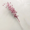 Macro detail of pink glitter Christmas berry pick on light marble background - Pink