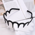 Detail shot of wavy black headband in a tray showing 12.5CM diameter measurement - Black Lacquered (Wave Wide)