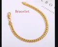 Detailed close-up of a 5mm gold plated Cuban link chain bracelet with lobster clasp closure - Bracelet / Gold