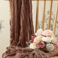 Elegant brown wrinkled gauze table runner draped on chair with decorative floral bouquet - Coffee