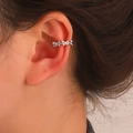 Detailed view of silver clip-on earrings with three butterfly zircon stones on ear - Triple Butterfly Ear Cuff (03 White K 1337) / 1 Pair Pack / Silver