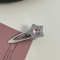 Close-up of a silver star hair clip with pink rhinestones on a decorative card - Silver/Pink Zirconia-Star Crystal