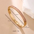 Detail shot of gold-plated stainless steel bangle with inlaid pink rectangular crystals - Pink Zirconia - Gold