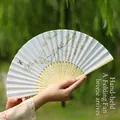 Blue folding fan with traditional flower and bird pattern, carved bamboo ribs and tassel - Birds and Fallen Flowers