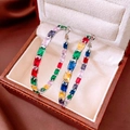 Macro shot of silver hoops featuring rectangular colorful gemstones in a jewelry box - Silver Style (Silver Pin)