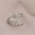 Makro-Detail des silbernen Weizenblatt-Rings auf elegantem Champagner-Satinhintergrund - Kreativer Sicherheitsnadel Offener Stil (J361-2)