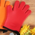 Red heat resistant silicone oven mitts with heart patterns on a wooden table - China Red