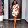 Detailed view of two-piece cream outfit with red geometric prints on shirt and shorts - 2XL / Cream White Print