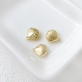 Three 14k gold-plated shell pendants displayed on a white textured ceramic tray - 13# Shell