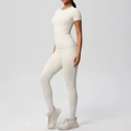 Detail view of cream white yoga set featuring side pocket leggings and slim fit t-shirt - Light Ivory