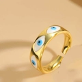 Macro detail of adjustable gold enamel ring featuring a blue evil eye rhombus design - White