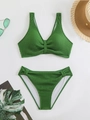 Detailed flat lay of green smocked texture bikini set with stylish summer holiday accessories - Army Green