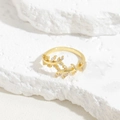 Elegant gold leaf branch ring with sparkling cubic zirconia on a white stone background - Tree Branch Zircon / 14K Gold