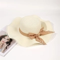 Close-up of woven straw hat featuring a brown ribbon bow and elegant pearl accents - Adult 56-58cm / Cream