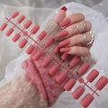 Detail of matte dusty pink long square press-on nails shown on a soft fabric background - Matte Smoky Pink