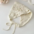 Detailed top-down shot of cream-colored crochet knit headscarf with handmade floral accents - Cream White Knitted